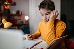 A teenage boy doing his homework at home A boy studying