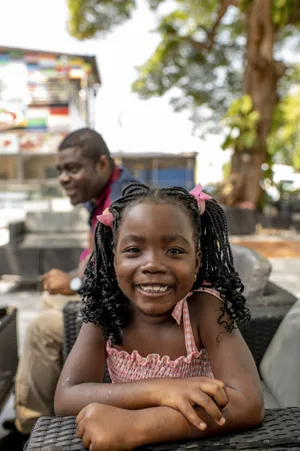 Hugo smiles in Cotonou, Benin Dealing with digital girls. Girls with a father