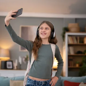 Teenage girl making video call holding smartphone Ein Mädchen fotografiert sich mit dem Handy.