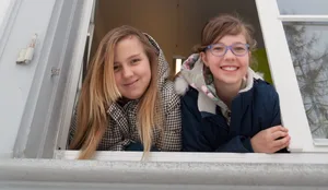 Day school: two schoolgirls look out of the window Day school: two schoolgirls look out of the window