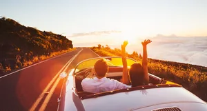 L_time_out_for_parents Time out and driving away without children. A couple drive towards the sunset in a convertible.