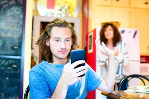 Boy_wants_to_stay_on_mobile_phone_and_waves_mother_off-scaled the fear of missing something on the smartphone