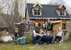 The Luigjes family in front of their playhouse in the garden The Luigjes family in front of their playhouse in the garden