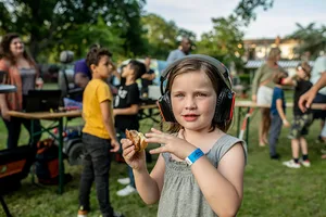 Molly wearing headphones at the silent disco at Majella Parc A girl wearing headphones is holding a sandwich