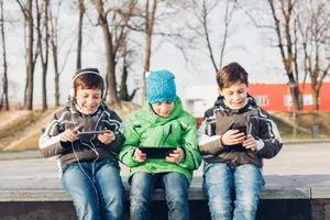 Jungs-draussen-am-Handy-spielen-mit-Outdoor-Apps Outdoor Apps für Kinder