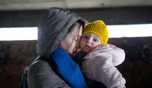 Women: Mother hugs her child Women: Mother hugs her child